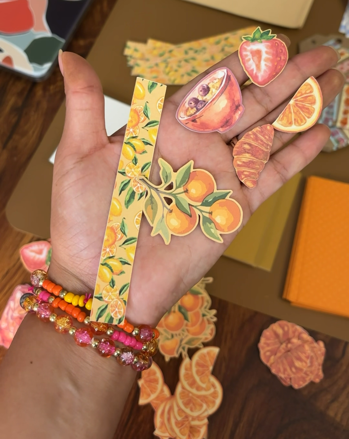 Hand holding ephemera pieces from a creative kit